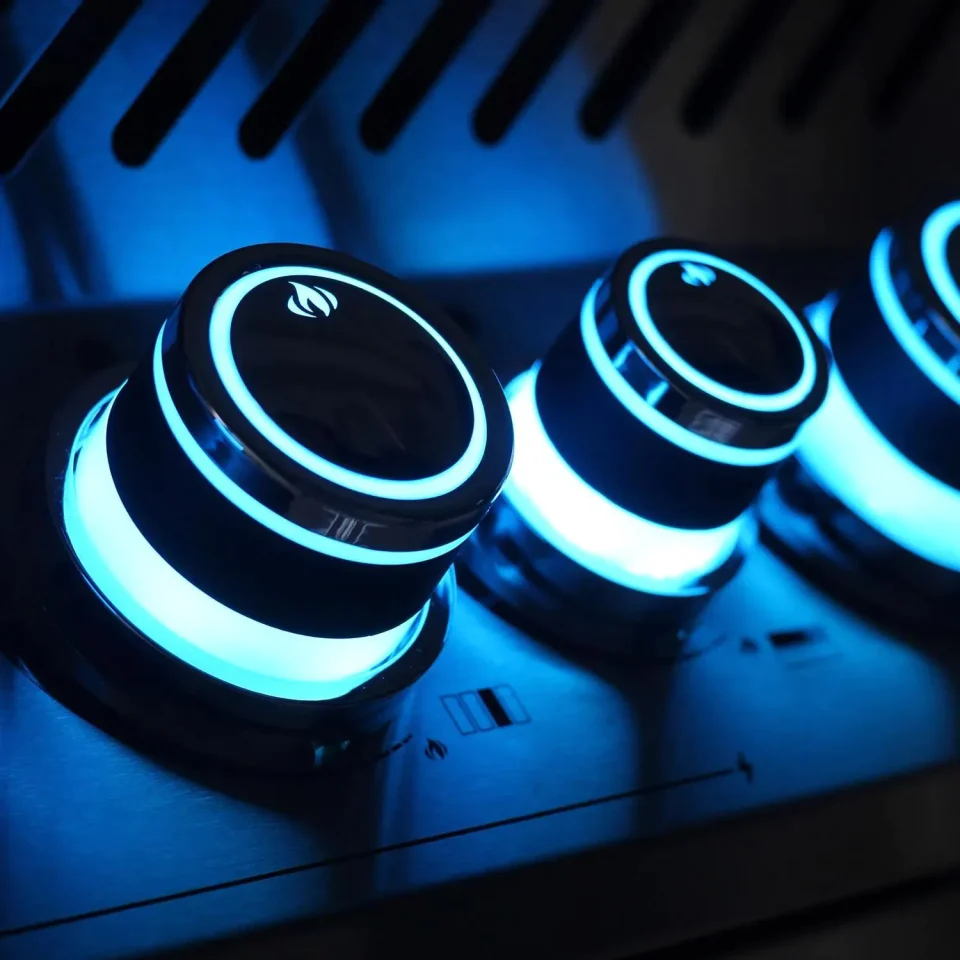 Napoleon NIGHT LIGHT™ control knobs glowing blue for nighttime grilling visibility