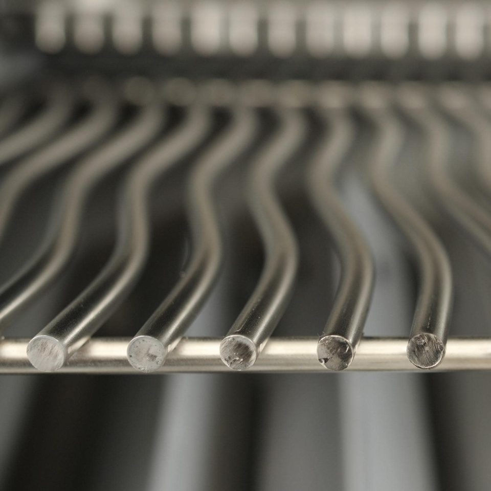 Close-up of Napoleon grill's 304 stainless steel WAVE™ cooking grates, highlighting high-end BBQ grill construction