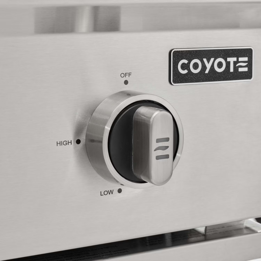 Close-up of Coyote C-Series grill control knob with no lighting, showcasing standard stainless steel finish.