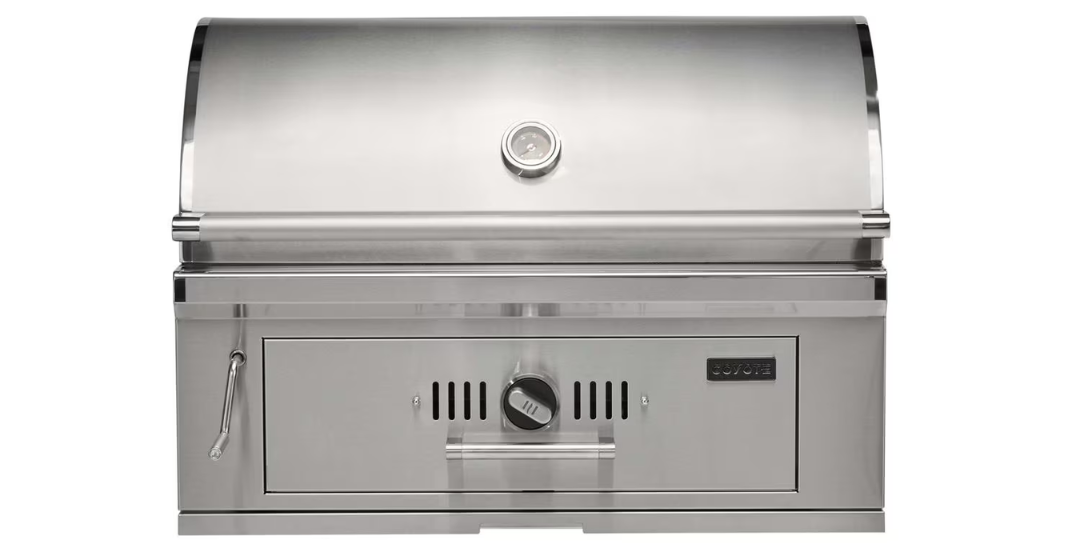 Coyote 36-Inch Built-In Charcoal Grill featuring 875 sq in of cooking space, height-adjustable coal tray, and twin airflow dampers — a top charcoal grill for outdoor kitchens.