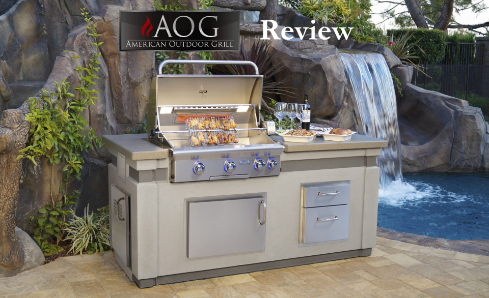 AOG built in grills installed in a luxury outdoor kitchen island with rotisserie setup, stainless steel drawers, and waterfall background.