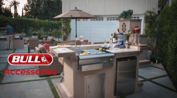 Bull BBQ Accessories including griddle, refrigerator, and storage built into a luxury outdoor kitchen island