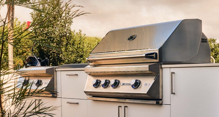 Sales on Twin Eagles C Series built-in grill with stainless steel outdoor cabinetry in a luxury backyard setting