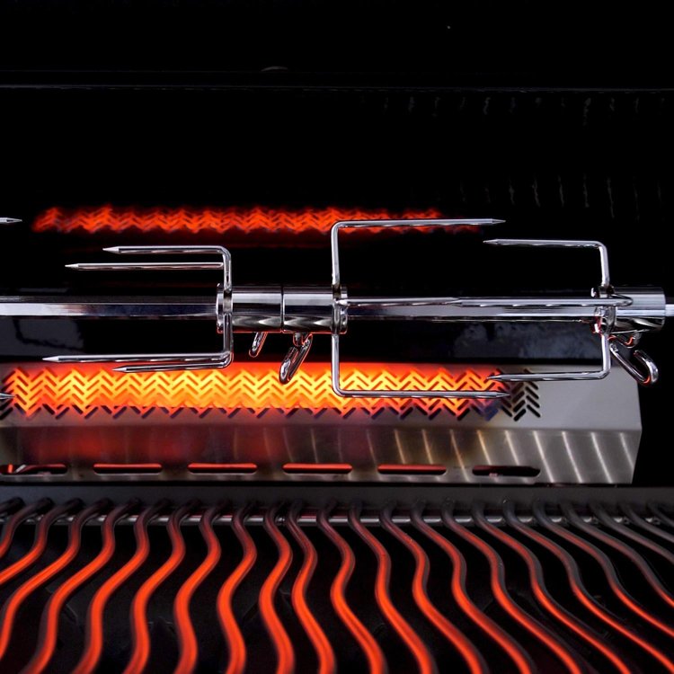BBQ grill infrared burner glowing on a Napoleon gas grill with rotisserie forks in front