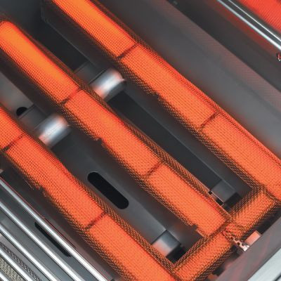 Top view of a Lynx Trident infrared burner glowing red during operation.