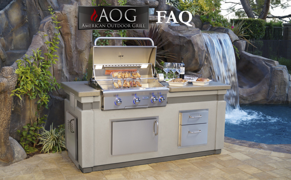 AOG Grills built-in BBQ island with stainless steel grill, side burner, and outdoor kitchen setup beside a pool and waterfall.