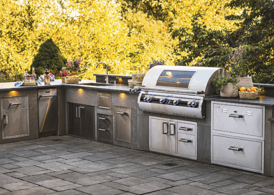 Outdoor kitchen featuring a premium Fire Magic built-in grill with storage and accessories—perfect for homeowners asking: Are Fire Magic Grills Worth It?