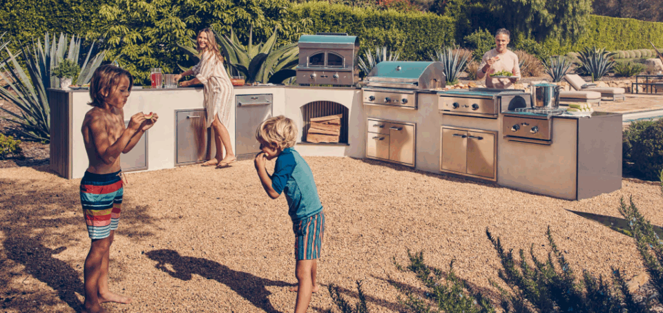 Delta Heat outdoor kitchen setup with family entertaining by the pool, premium built-in grills and appliances