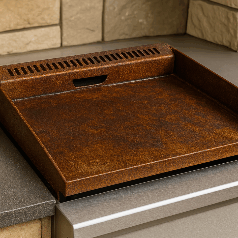 Close-up view of a heavily rusted flat top griddle installed in a BBQ island—shows corrosion issues common with carbon steel griddles like Blackstone when used outdoors.