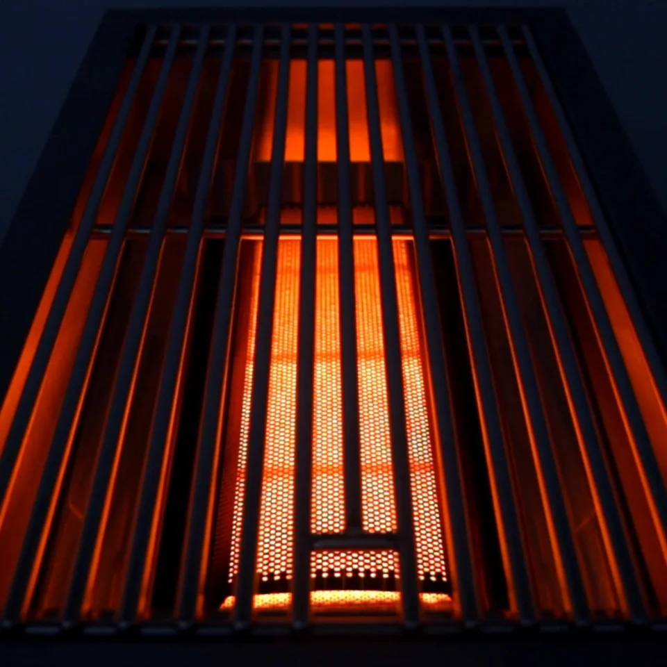 Sear burner glowing red-hot for grilling with infrared heat on steaks and burgers.