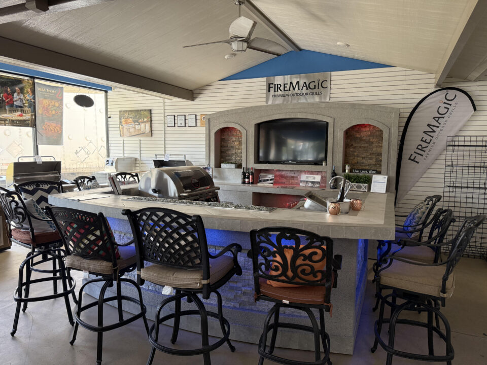 Fire Magic custom outdoor kitchen island display with bar seating and built-in grill at Best of Backyard’s Riverside showroom