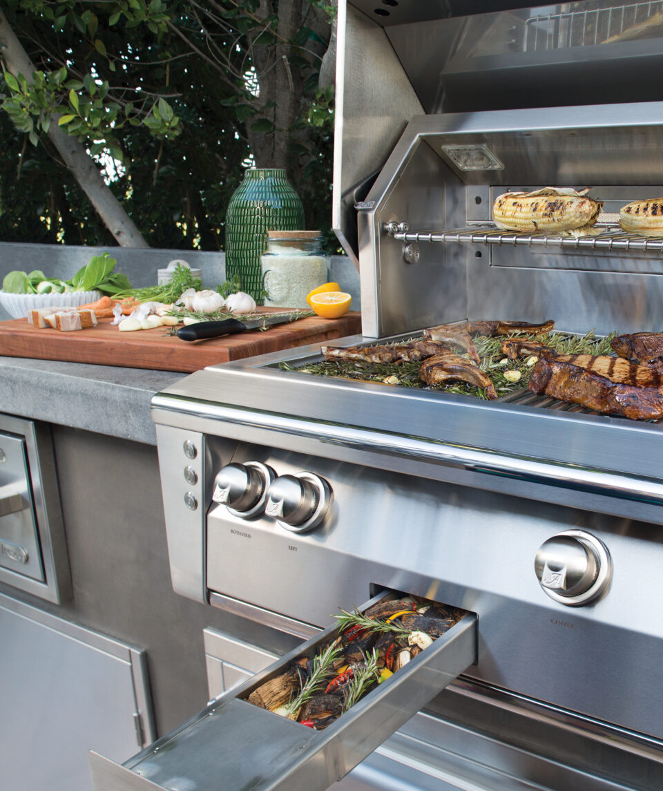 Alfresco luxury grill with Signature Taste™ integrated smoker drawer in use, showcasing restaurant-inspired outdoor cooking with fresh ingredients