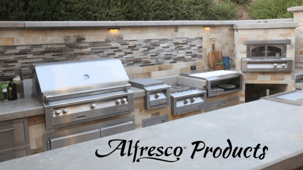 Luxury outdoor kitchen setup featuring Alfresco Grill Products, including built-in gas grill, side burners, and outdoor pizza oven