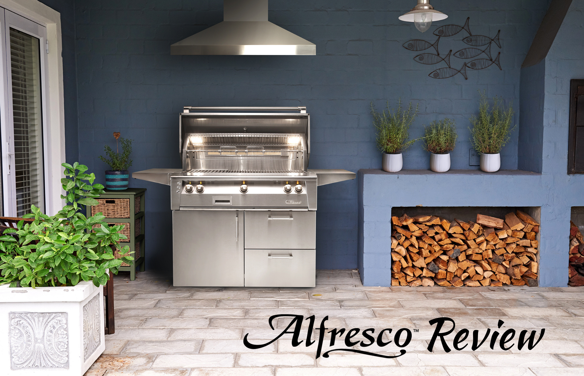 Alfresco Grills Review featuring a luxury stainless steel built-in grill setup with outdoor kitchen island, wood storage, and modern backyard design