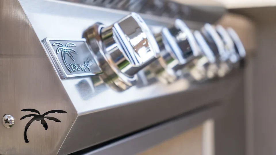 Close-up of KoKoMo Grills stainless steel control panel and logo badge